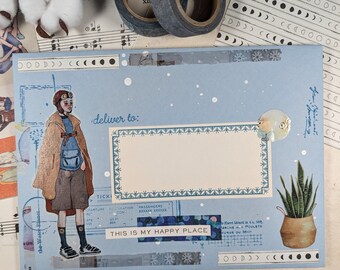May include: A blue envelope with a hand-drawn illustration of a person wearing a brown coat and a backpack. The envelope has a white rectangle with the text "deliver to:" and a blue and white patterned border. The envelope also has a sticker that says "This is my happy place".