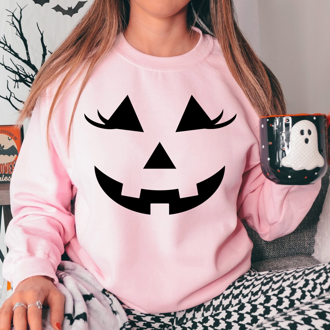 Pink Halloween Sweatshirt, Pumpkin Face Eyelashes, Pink Womens Halloween Crewneck Sweatshirt