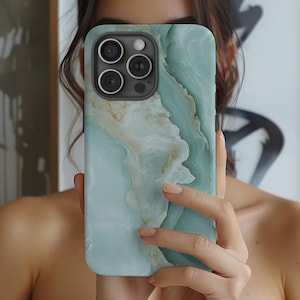 May include: A green and white marble phone case with a camera lens cutout. The case has a swirling pattern.