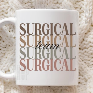 May include: A white ceramic mug featuring the word SURGICAL repeated four times in a stacked vertical layout. The text appears in varying muted earth tones including brown, tan, sage green, and dusty rose. The word team is written in black script.
