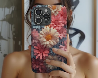 Può includere: Una custodia per telefono con un design floreale con fiori rosa, bianchi e blu. La custodia ha un ritaglio per l'obiettivo della fotocamera e un bordo nero.