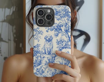 May include: A white iPhone case with a blue and white toile pattern featuring a golden retriever and other dogs. The case has a camera lens cutout and a white background.