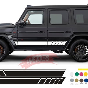 May include: Black and white side door decals for a car. The decals have a geometric design with a white stripe and black accents. The decals are shown on a black SUV.