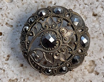 Openwork and cut steel button.