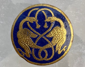 Enamel button with dragon supporters.