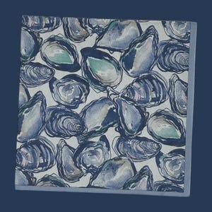 May include: Square, light-colored fabric with a repeating pattern of blue and gray oyster shell illustrations. The shells have a watercolor effect with hints of green. The fabric is bordered by a solid blue edge.