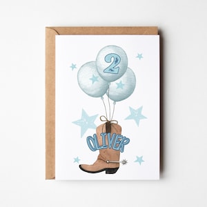 May include: A white card with a blue number 2 on a blue balloon, three blue balloons, and a brown cowboy boot with the name Oliver on it. The card is surrounded by blue stars.