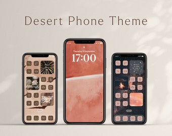 May include: Three iPhone mockups displaying a desert-themed phone theme. The center phone shows a pink and orange gradient background with the time "17:00" displayed. The left phone shows a brown background with icons and text including "Flourish" and "Desert Soul". The right phone shows a dark background with icons and text including "Look up at the stars, not down at your feet".