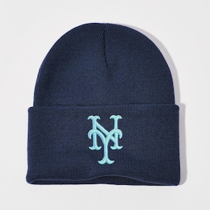 May include: A navy blue beanie with a light blue embroidered New York Yankees logo.