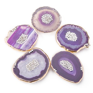 May include: Five purple agate coasters with gold trim and clear rhinestone accents.