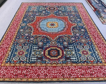 May include: A large, intricately patterned rug with a central medallion in shades of red, blue, and yellow. The rug has a dark blue background with a red border and intricate geometric designs.