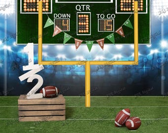 May include: A football-themed backdrop featuring a green scoreboard with the text HALF TIME, HOME, VISITOR, QTR, DOWN, and TO GO. A yellow goalpost stands on a green field with a wooden crate, a white 1/2 sign, and three brown footballs.