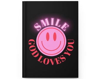 May include: Black notebook with a pink smiley face and the text "SMILE GOD LOVES YOU" in red.