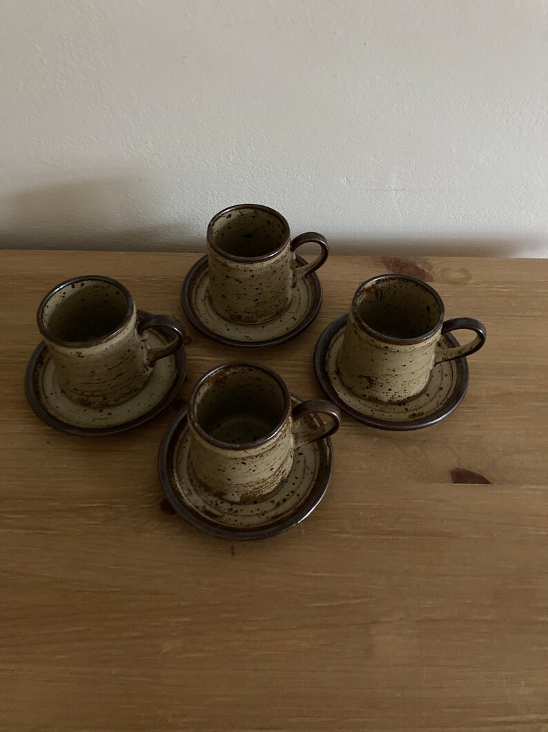 May include: Set of four brown and beige speckled ceramic coffee cups with matching saucers.