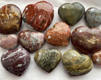 May include: Ten heart-shaped polished stones with various patterns and colours, including red, brown, white, and grey. The stones are labelled with letters A through K.