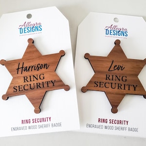 May include: Two wooden sheriff's badges with the text "Ring Security" and the names "Harrison" and "Levi" engraved on them.