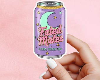 May include: A sticker depicting a soda can with a purple body, a gold glitter rim, and the words "Fated Mates" in pink script. A green crescent moon and stars decorate the can. The text "Eternal Sparkle Soda" is below the main text.