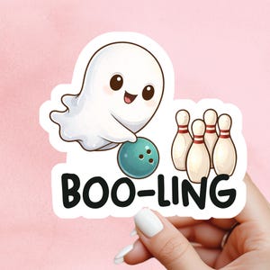 May include: A sticker showing a cartoon ghost with a teal bowling ball and four bowling pins. The text "BOO-LING" is below the ghost. The ghost has a happy expression.