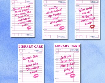 May include: Five library card designs with pink text and lipstick kiss graphics. Each card features a different quote about books and reading. The cards are set against a watercolour background.