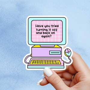 May include: A sticker featuring a retro computer design in pastel colours. The computer screen displays the text "Have you tried turning it off and back on again?" A mouse is connected to the computer.