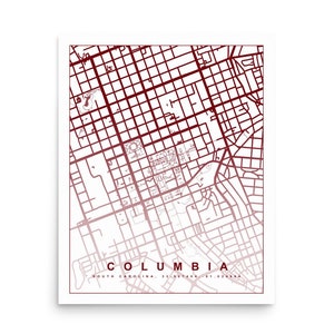 May include: A red and white map of Columbia, South Carolina. The map shows the city's streets and landmarks. The text "COLUMBIA" and "SOUTH CAROLINA" is printed at the bottom of the map.