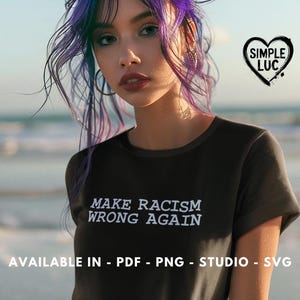 May include: A woman with purple hair is wearing a black t-shirt with the text "MAKE RACISM WRONG AGAIN" printed on it. The text is in white and is in a typewriter font. The woman is standing in front of a beach with the sea in the background. The image also includes a heart with the text "SIMPLE LUC" inside of it.