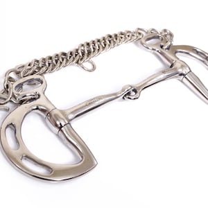 May include: A silver horse bit with a curb chain. The bit has a mouthpiece with a small, round, metal knob in the center. The bit is attached to a curb chain with a small, round, metal ring.