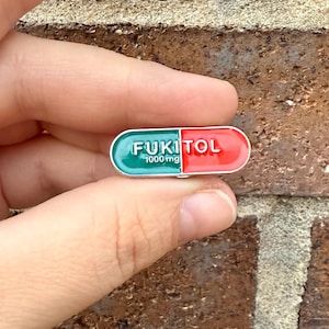 Fukitol Pill Enamel Pin – Funny Mood Booster, Unique Pin for Jackets, Bags, Hats, & More!