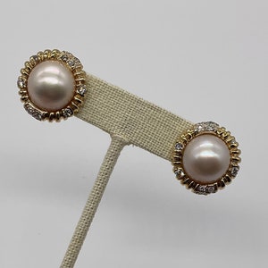 May include: A pair of gold earrings with a pearl and diamond accents.