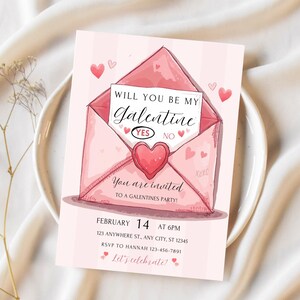 May include: A pink Galentine's Day invitation card featuring a watercolor illustration of an envelope with a heart. The card reads "Will You Be My Galentine?" with "Yes" and "No" options. Additional text includes party details.