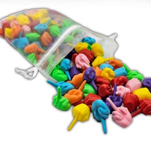May include: A bag of colorful, small, plastic, finger-shaped toys. The toys are in various colors, including red, orange, yellow, green, blue, purple, and pink.