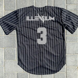 May include: Black and white striped baseball jersey with the word "ILLENIUM" and the number "3" on the back.