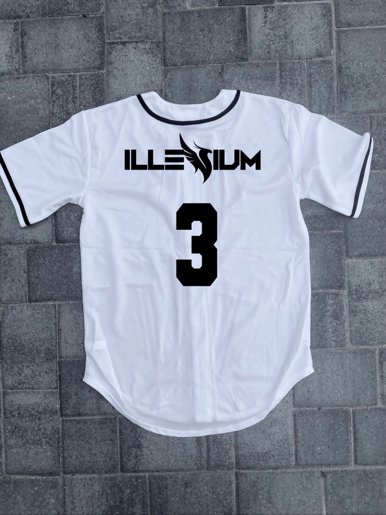 May include: White baseball jersey with black trim and the text "ILLESIUM" and the number "3" on the back.