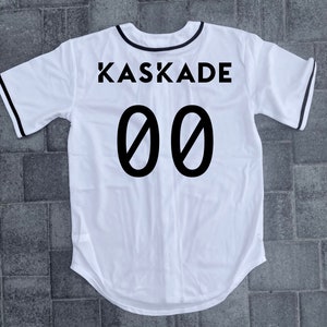 May include: White baseball jersey with black trim and the text "KASKADE 00" printed on the back.