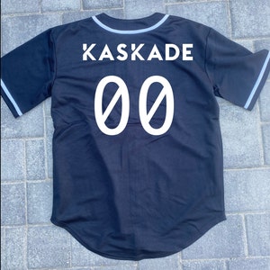 May include: Black baseball jersey with white trim and the text "KASKADE 00" on the back.