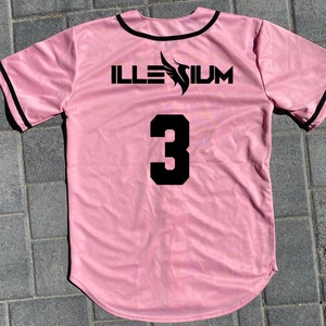 May include: Pink baseball jersey with black trim and the word "ILLESIUM" and the number "3" printed on the back.