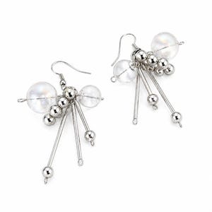 May include: A pair of silver-toned dangle earrings. Each earring features a large, clear, round bead, smaller silver beads, and dangling silver rods with beads at the ends. The earrings have a hook closure.