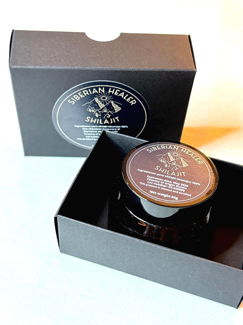 May include: A black box with a gold label that reads "Siberian Healer Shilajit" and a smaller black box with a gold label that reads "Siberian Healer Shilajit" inside. The label includes the ingredients, expiration date, country of origin, lot number, and net weight of 50g.