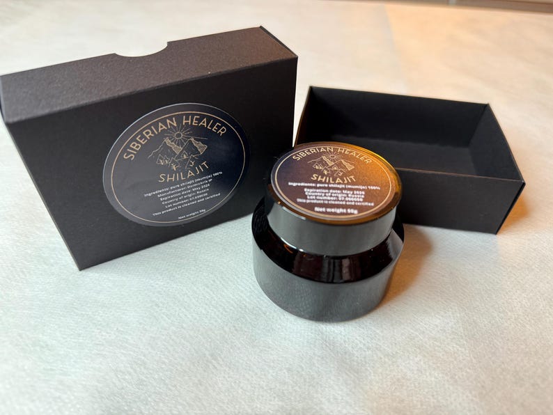 May include: A black box with the text "Siberian Healer Shilajit" on the front. The box contains a black jar of Shilajit, a natural substance.