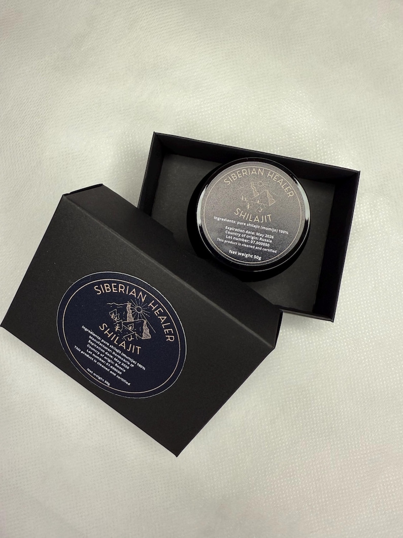 May include: A black box with a gold label that reads "SIBERIAN HEALER SHILAJIT" and contains a small black jar with a gold label that reads "SIBERIAN HEALER SHILAJIT". The jar contains a dark brown substance. The label on the jar includes the ingredients, expiration date, country of origin, lot number, and net weight.