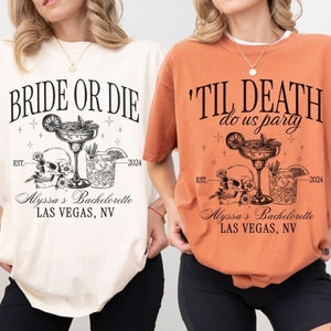 May include: Two white and orange t-shirts with a skull and crossbones design and the text "Bride or Die" and "'Til Death Do Us Party". The shirts also include the text "Alyssa's Bachelorette Las Vegas, NV" and the years "EST. 2024".