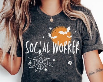 May include: Dark grey heather t-shirt with a white graphic design featuring a spider web, bats, a moon, and the text "SOCIAL WORKER".