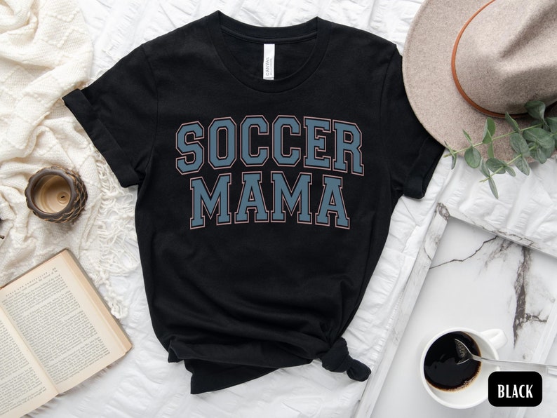 May include: Black t-shirt with the text "SOCCER MAMA" in blue and pink lettering.