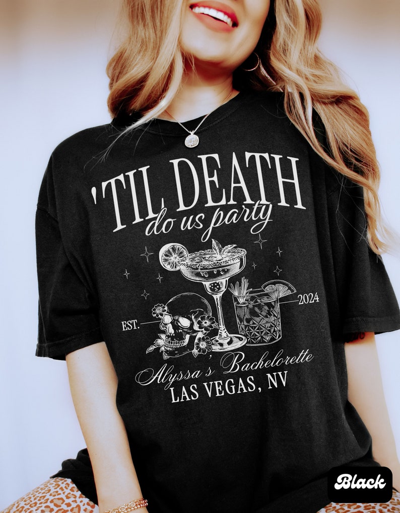 May include: Black t-shirt with white text that reads "'Til Death Do Us Party" with a skull and crossbones, two cocktails, and the text "Est. 2024 Alyssa's Bachelorette Las Vegas, NV".