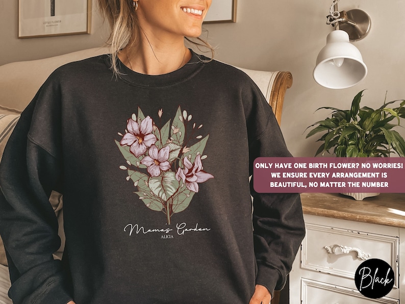 May include: Black sweatshirt with a floral design and the text "Mamas Garden ALKIA". The text below the design reads "ONLY HAVE ONE BIRTH FLOWER? NO WORRIES! WE ENSURE EVERY ARRANGEMENT IS BEAUTIFUL, NO MATTER THE NUMBER".