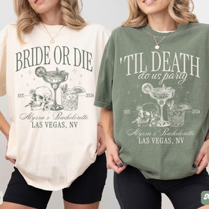 May include: Two white t-shirts with black text and graphics. The first shirt says "Bride or Die" with a skull and crossbones and two cocktails. The second shirt says "Til Death Do Us Party" with a skull and crossbones and two cocktails. Both shirts have the text "Alyssa's Bachelorette Las Vegas, NV" and the year "2024".