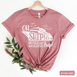 May include: Heather mauve t-shirt with a white graphic of a cruise ship and the text "Oh Ship! It's a Mother and Daughter Trip!"