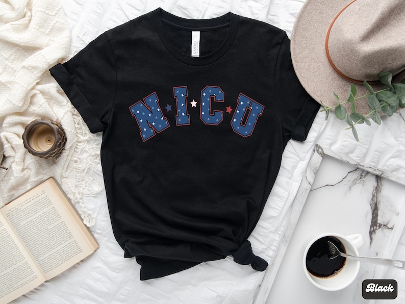 May include: Black t-shirt with a blue and red "NICU" graphic with white stars. The shirt is made of a soft, comfortable material.