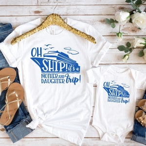May include: White t-shirts with blue text and a blue ship graphic. The text reads "Oh Ship! It's a Mother and Daughter Trip!"