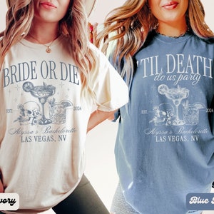 May include: Two t-shirts with a bachelorette party theme. The ivory t-shirt says "Bride or Die" and the blue jean t-shirt says "Til Death do us party". Both shirts feature a skull and two cocktails with the text "Alyssa's Bachelorette Las Vegas, NV" and the years "EST. 2024".